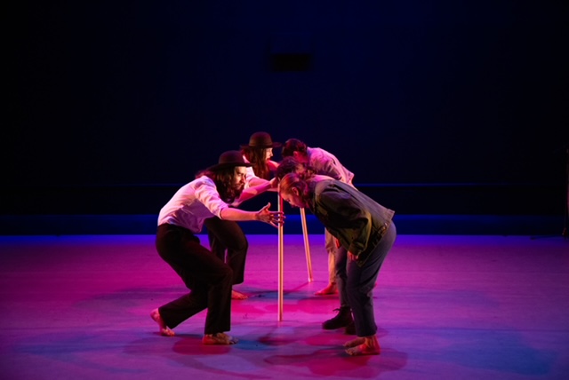 two lines of dancers face each other, bendoing forward as if in homage and conversations